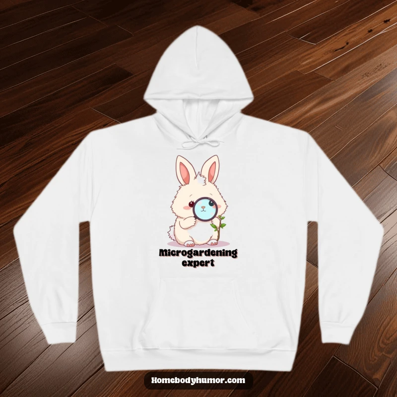 Funny Bunny Hoodie: A fluffy bunny with a magnifying glass studying a tiny plant, offering warmth and funny charm. A superb funny gift.