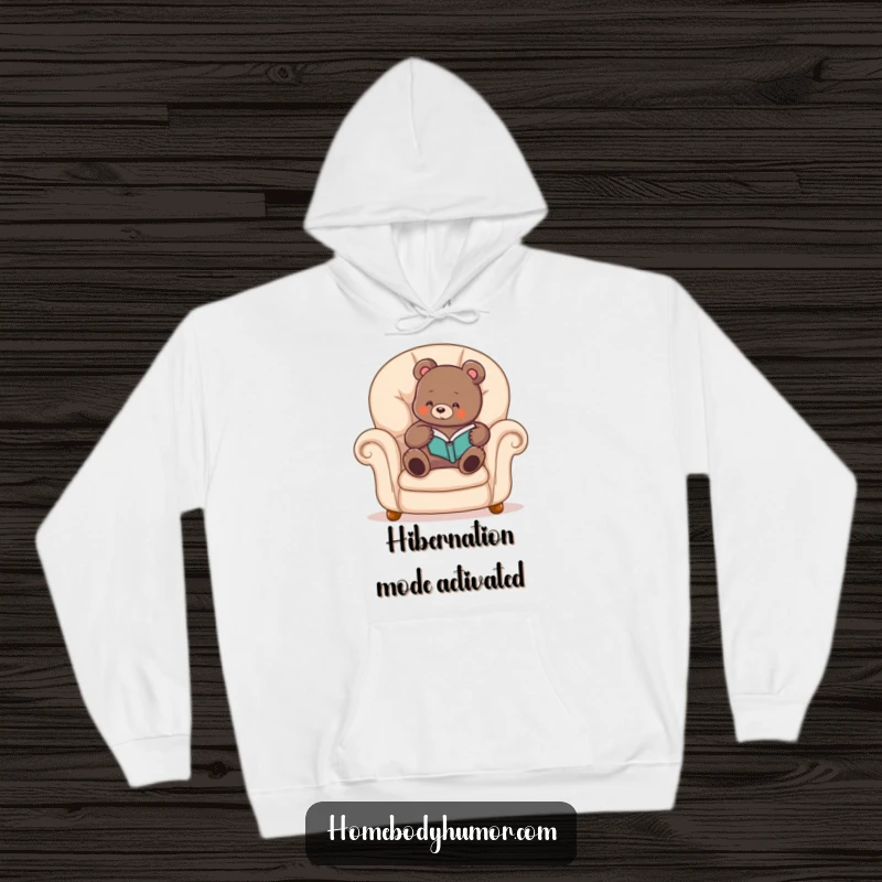 Funny bear hoodie showing a cozy bear reading a book in a plush armchair, designed for maximum comfort and relaxation.