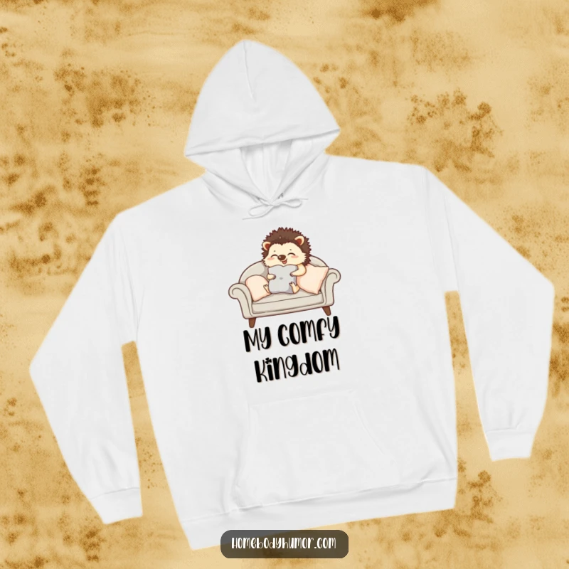 Giggling hedgehog carefully arranging cushions on a sofa hoodie, a warm and humorous top for cozy living.