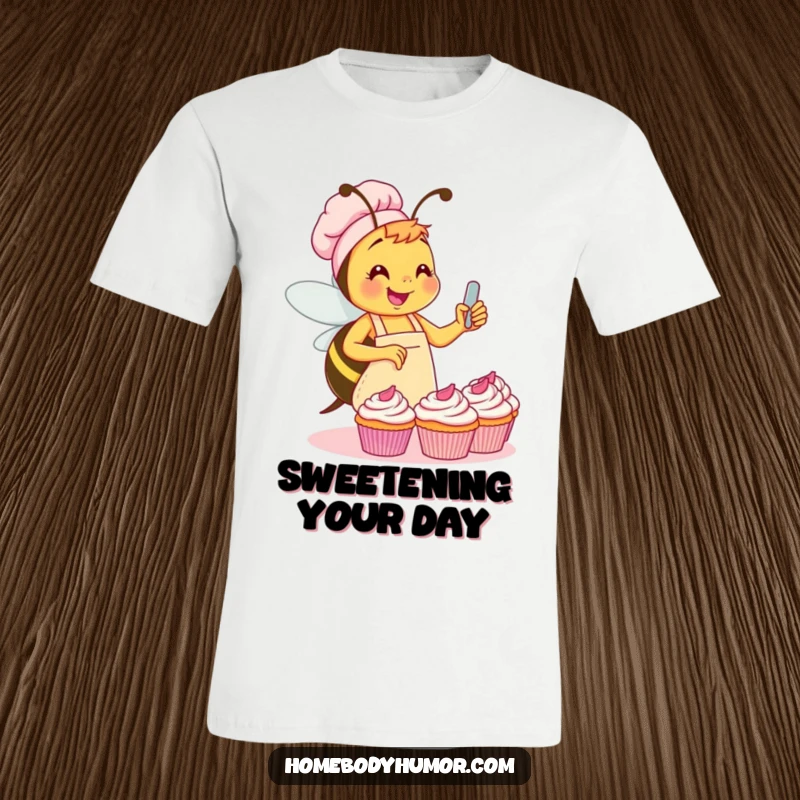 Funny Bee Cupcake T-Shirt: A busy bee wearing an apron, joyfully frosting a cupcake with a big smile. A truly funny gift.